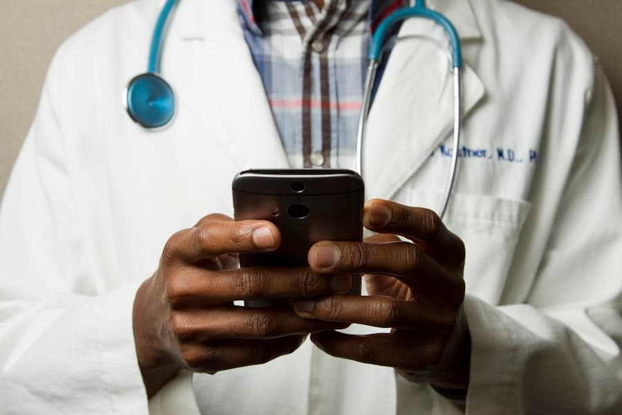 Clinician reviewing a patient chart on a tablet in a modern hospital